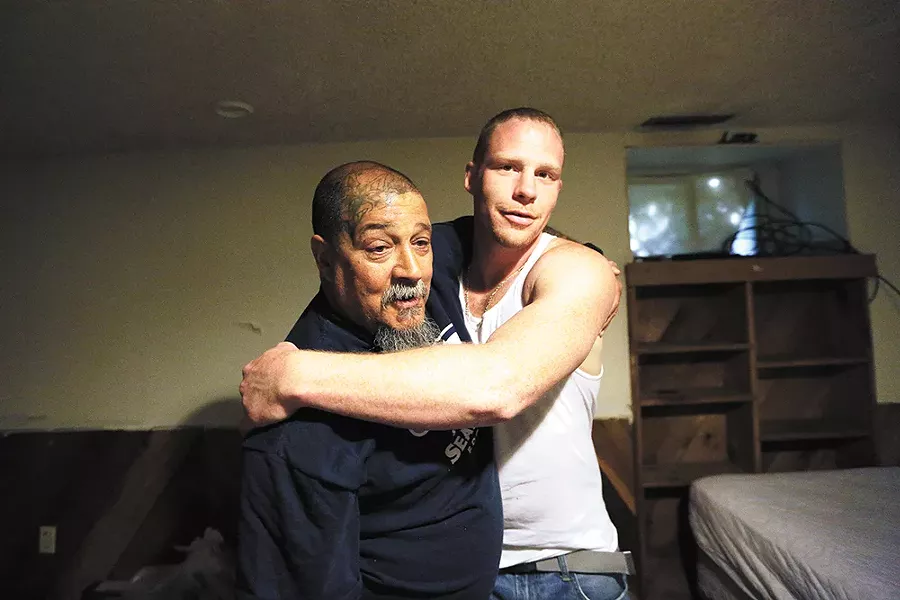 Randy Mora gets a hug from his new roomie Kyle Phillips on April 26. - YOUNG KWAK