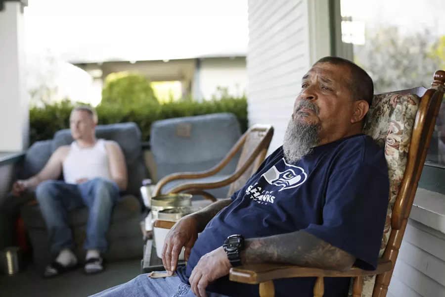 Randy Mora (right) sits on his front patio with Kyle Phillips, his roommate. - YOUNG KWAK