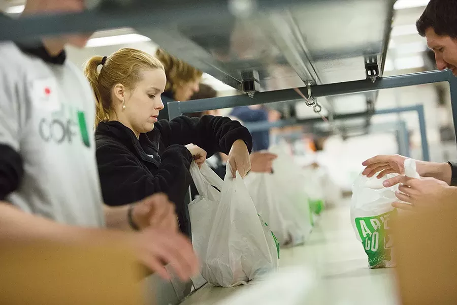 Volunteers sort donations at 2nd Harvest. - YOUNG KWAK