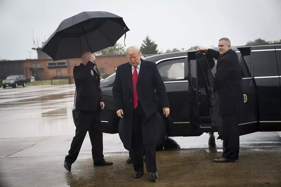President Donald Trump speaks to reporters at Joint Base Andrews in Maryland, Oct. 27, 2018. A new lawsuit accuses Trump, his company and three of his children of using the Trump name to entice vulnerable people to invest in sham business opportunities. - DOUG MILLS/THE NEW YORK TIMES