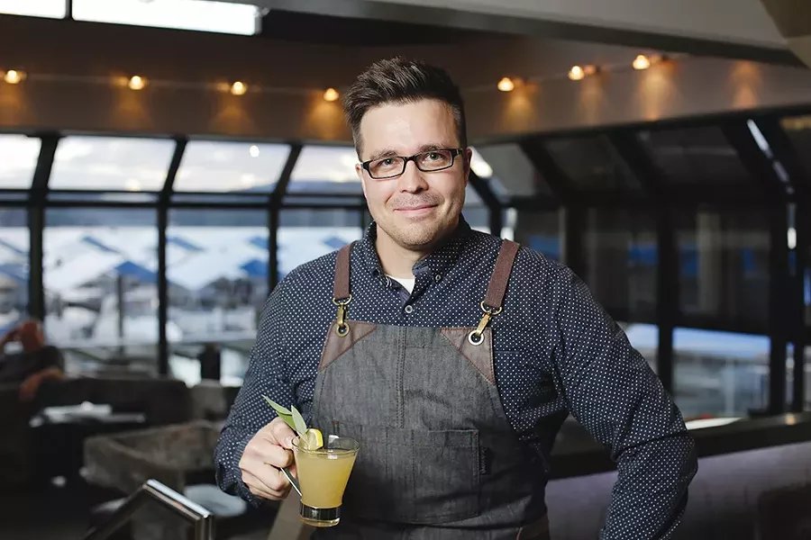 Justin Schorzman holds a Honey Sage Toddy at the Coeur d'Alene Resort's Whispers lounge. - YOUNG KWAK