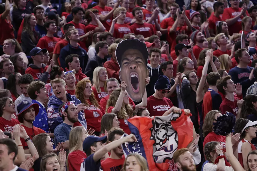 A fan holds a cutout photograph of Gonzaga forward Rui Hachimura. - YOUNG KWAK
