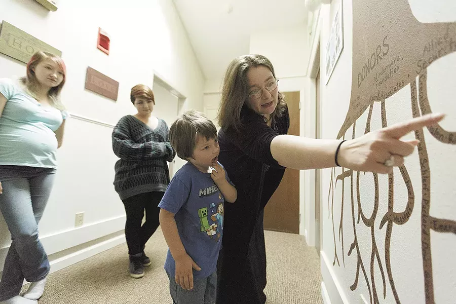 Angela Friedrich shows her 5-year-old son, Bert, a mural representing the donors who contributed to Family Promise of Spokane, which has helped the Friedrich family. - YOUNG KWAK