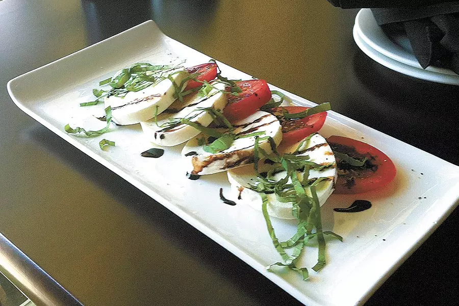 The salad caprese at Uva Trattoria's new downtown Coeur d'Alene location. - CARRIE SCOZZARO