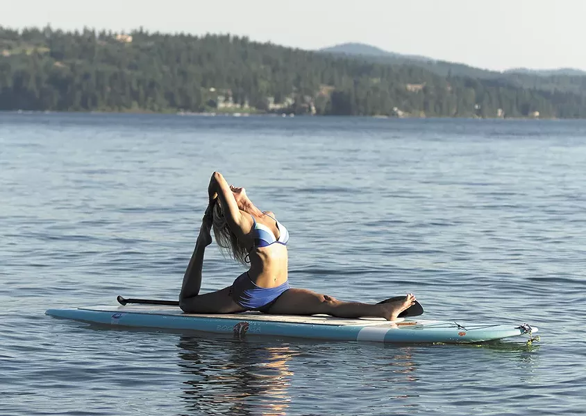 Coeur d’Alene Paddle Board instructor Kim Sherwood doing yoga. - YOUNG KWAK