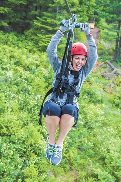 Laura Regester soaring down a zip line. (below) A tour (above) at Mica Moon. - ROD JEFFERS PHOTOS