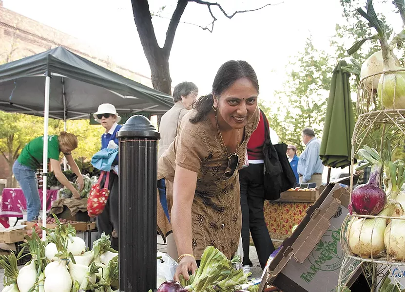 A customer looks through goods from Pokey Creek Farm at the Moscow Farmers Market. - ALISON MEYER