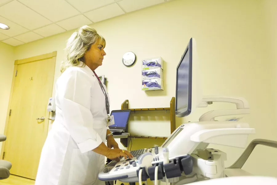 Ultrasound team leader Julie Bronson demonstrates how she uses ultrasound at Inland Imaging. - YOUNG KWAK