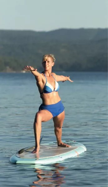 Kim Sherwood demonstrates a warrior pose on Lake Coeur d’Alene. - YOUNG KWAK