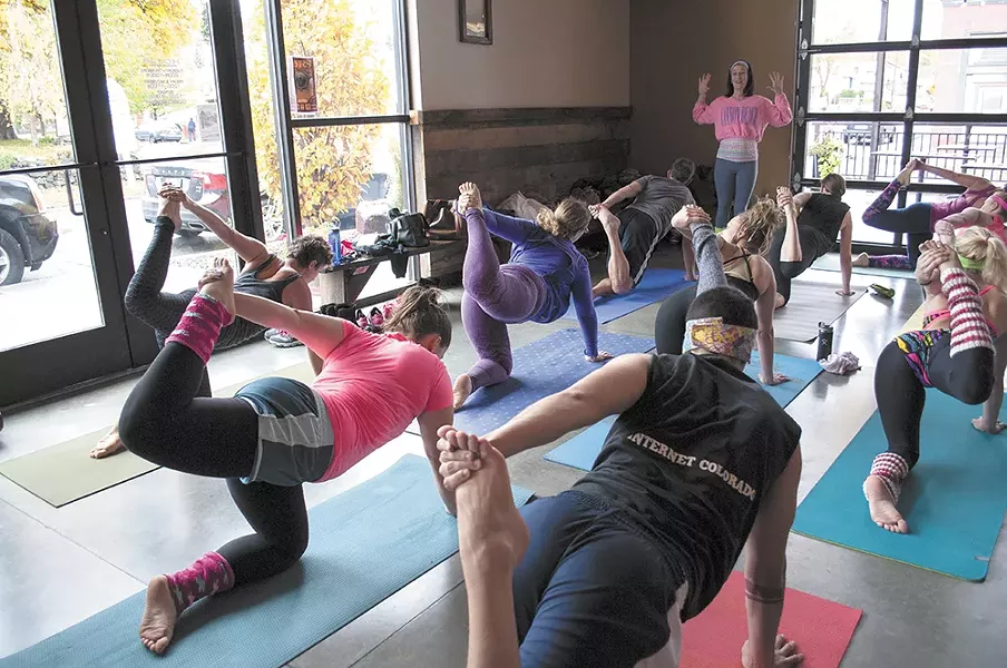 Students focus on a pose at Spokane's Perry Street Brewing. - SARAH PHILIP