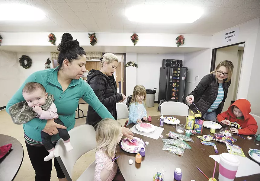 Melissa Strohe (left) and other mothers help their kids with a crafts activity during one of the North Spokane MOMS Club's weekly social events. - YOUNG KWAK