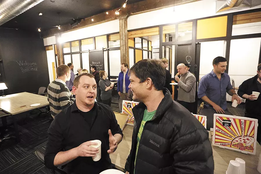 Build Guild coordinator Zach Shallbetter (left) visits with web developer Greg Neils during January's casual networking meetup for people of all backgrounds in the local tech/web industry. - YOUNG KWAK