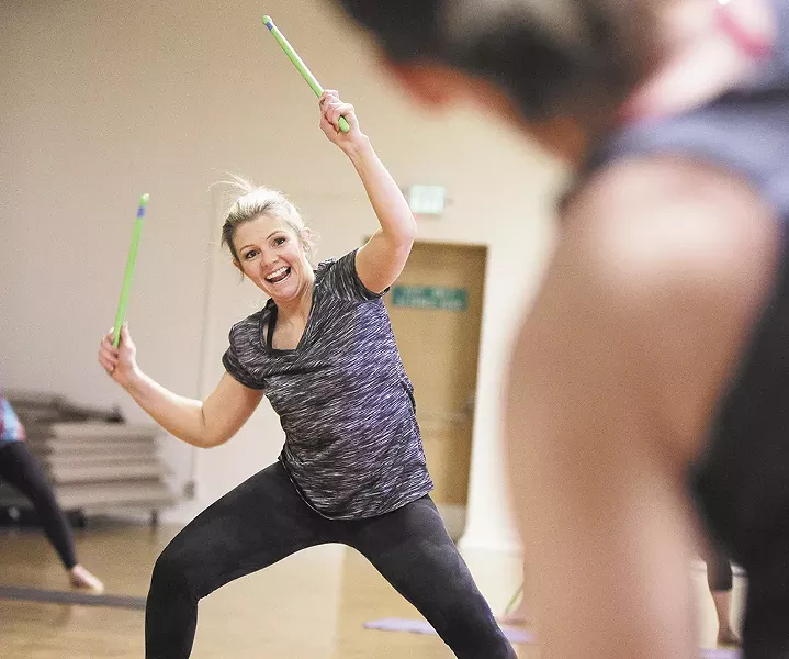 Nicole Baldwin's drumsticks fly during a POUND Pro class in Cheney. - YOUNG KWAK