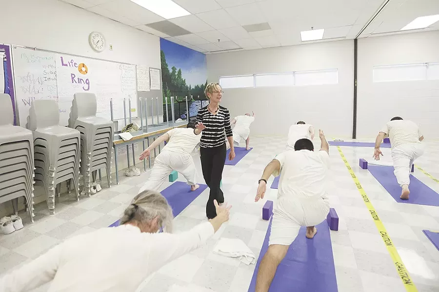 Volunteer Diane Sherman leads a yoga class for inmates at Airway Heights Corrections Center. - YOUNG KWAK