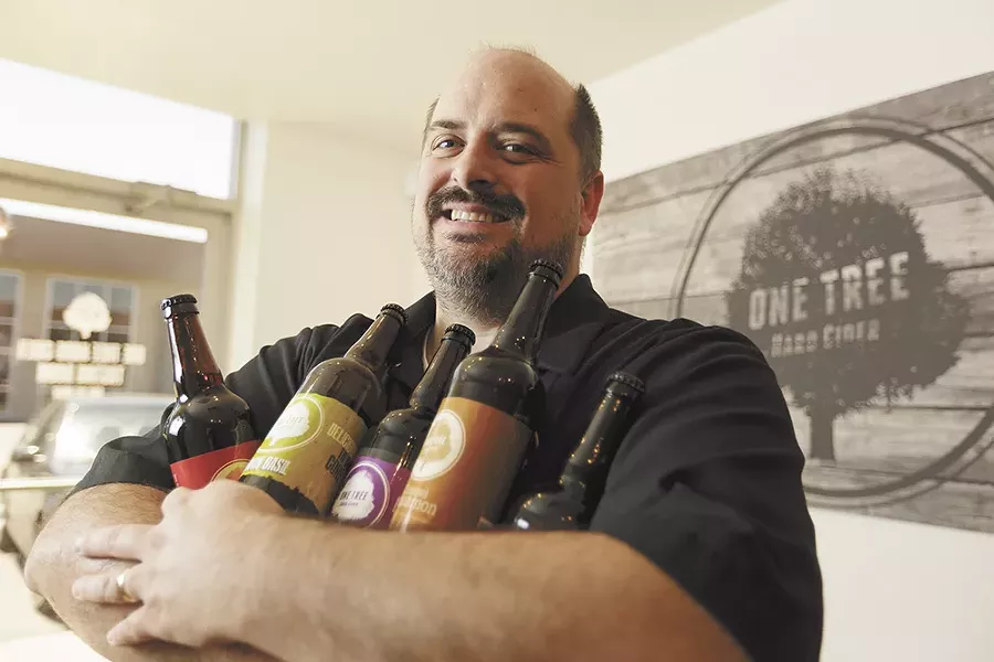 One Tree Hard Cider's Neal Hennessy with several varieties of his company's award-winning cider. - YOUNG KWAK