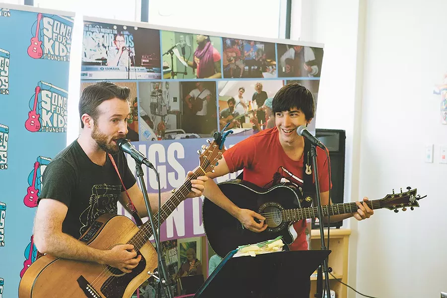 Scott Ingersoll (left) and Miles Martin bring music to the Sacred Heart Children's Hospital every week. - KRISTEN BLACK