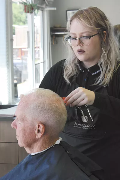 Barber Kendra McKay cuts Peter Joss's hair. - LAURA JOHNSON