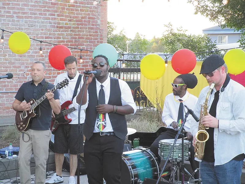 Omy's ban playing at a recent fundraiser on the Saranac rooftop. - DAN NAILEN