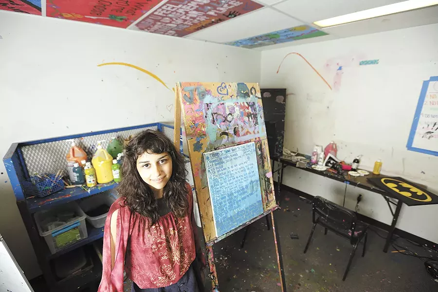 Angelina ended up in The Jungle, Seattle's infamous homeless encampment, where she says she was sold to a man in exchange for drugs. Here she's seen next to a painting she made during her in-patient treatment at Daybreak Youth Services in Spokane. - YOUNG KWAK
