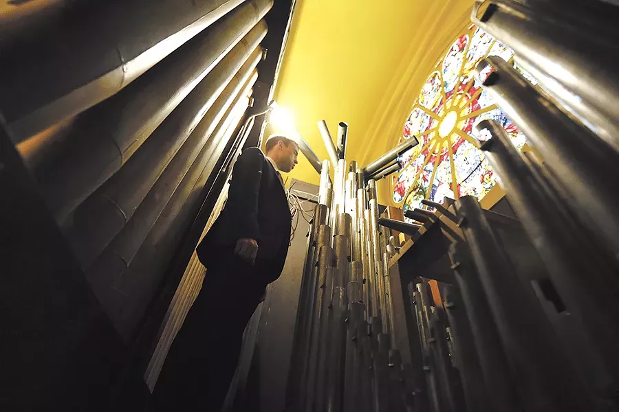 Music director Robert Carr inside the cathedral organ. - YOUNG KWAK