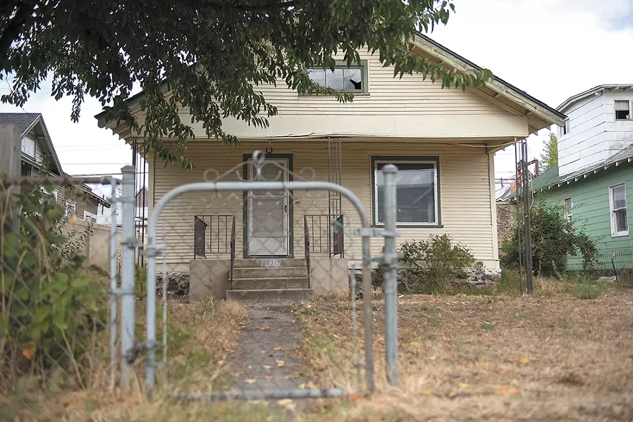This Bridge Avenue property, owned by the city of Spokane's Chief Financial officer Gavin Cooley, has sat vacant for eight years, as Cooley has struggled to figure out how to deal with it. - DEREK HARRISON