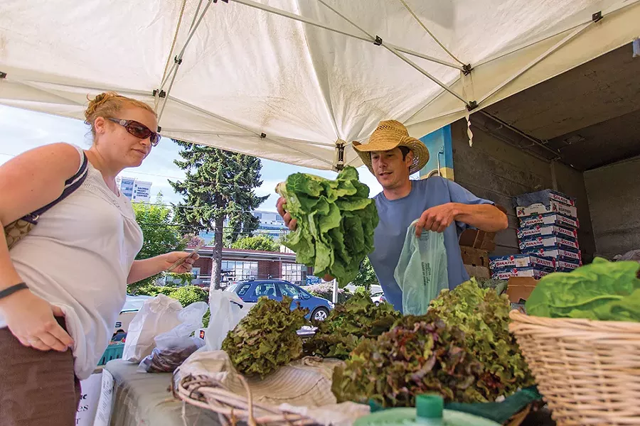Joe Piver of Tolstoy Farms sells local lettuce at the Spokane Farmers Market. - MATT WEIGAND