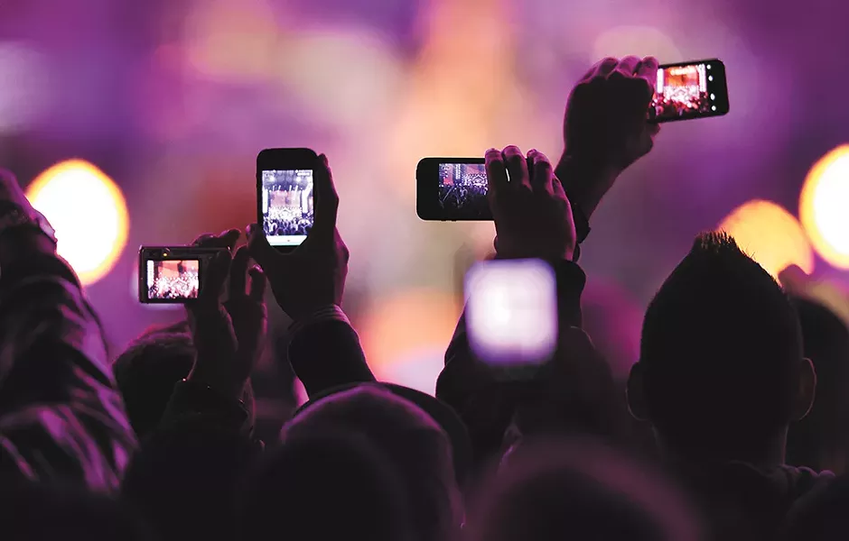 People are viewing concerts through their hand-held screens more and more.