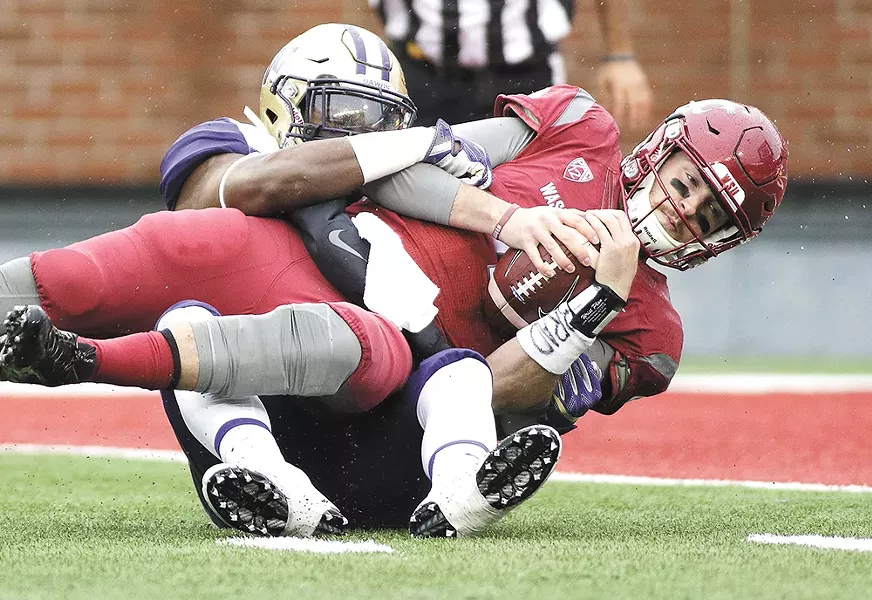 WSU quarterback couldn't get rolling against UW's defense. - YOUNG KWAK