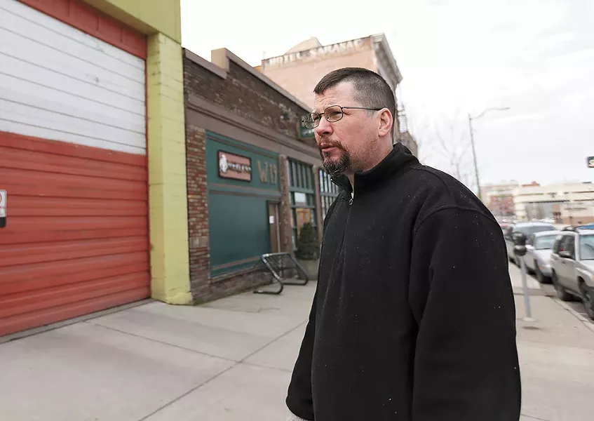 John Waite, owner of Merlyn's and Auntie's Bookstore, is counting on increased sales to make up for the cost of paying his employees more. - YOUNG KWAK