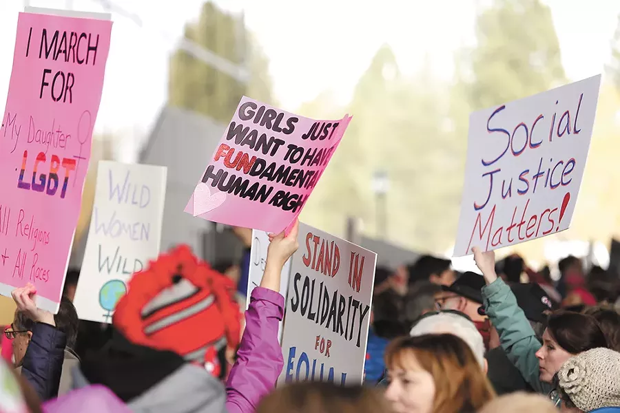 Signs proved a widely shared aspect of the day's marches around the world. - YOUNG KWAK