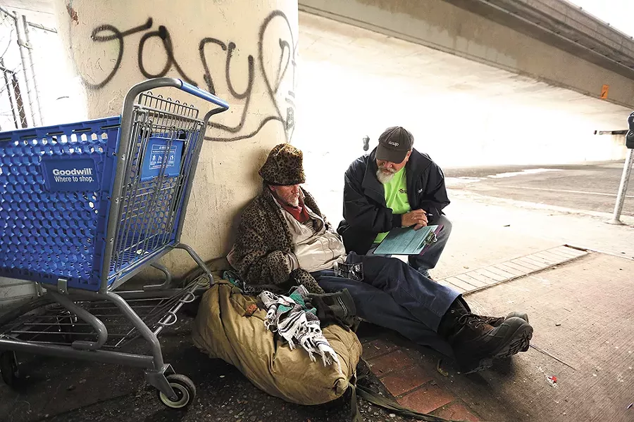 Social worker Bob Peeler talks to Anthony St. John about ways he might get off the street. - YOUNG KWAK