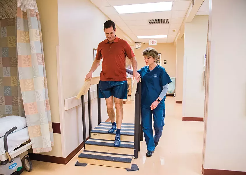 Outpatient surgery coordinator Sandy Phillip assesses Kimball’s stair climbing. - JENNIFER DEBARROS