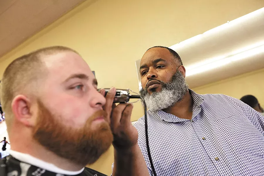 Jay Troutt, right, draws customers from across the region to his barbershop. - YOUNG KWAK