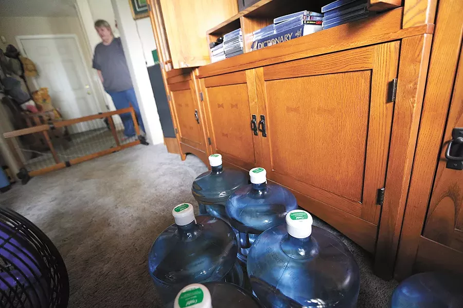 Residents are getting jugs of water, like these in Barb Collins' home. - YOUNG KWAK