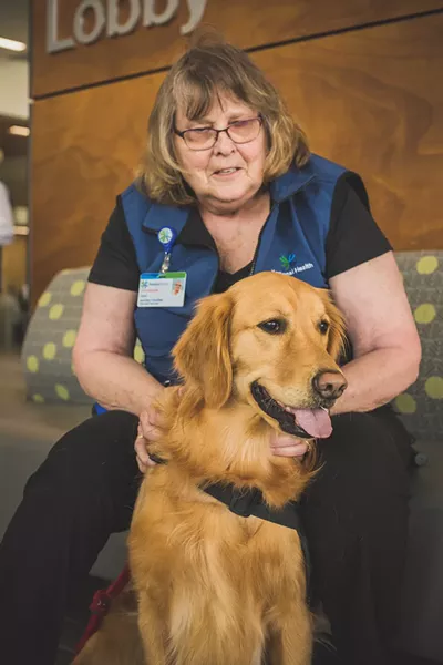 Carol Cook and her golden retriever, Molly, volunteer at Kootenai Health. - DAN COUILLARD