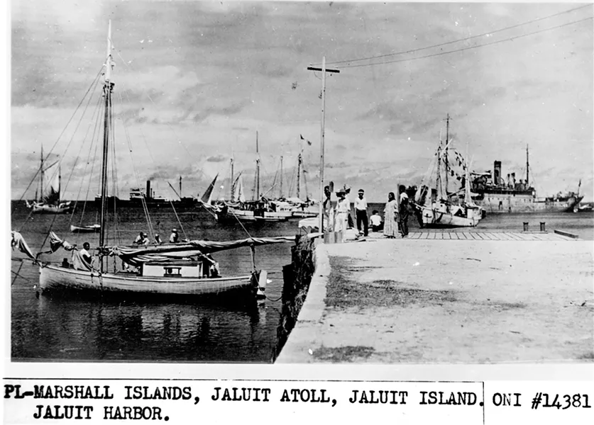 In an undated handout photo from the National Archives, what could be Amelia Earhart, seated with her back to the camera and Fred Noonan, her navigator, on the Jaluit Atoll in the Marshall Islands after their disappearance on July 2, 1937. Various forms of the theory that Earhart may have ended up in Japanese custody have been tossed around for decades, but the newly discovered photograph is breathing new life into the idea. - U.S. NATIONAL ARCHIVES VIA THE NEW YORK TIMES
