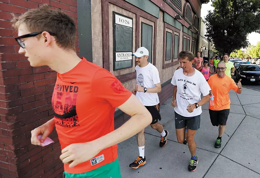 Runners take to the streets in the South Perry District as part of the Lantern Running Club. - YOUNG KWAK