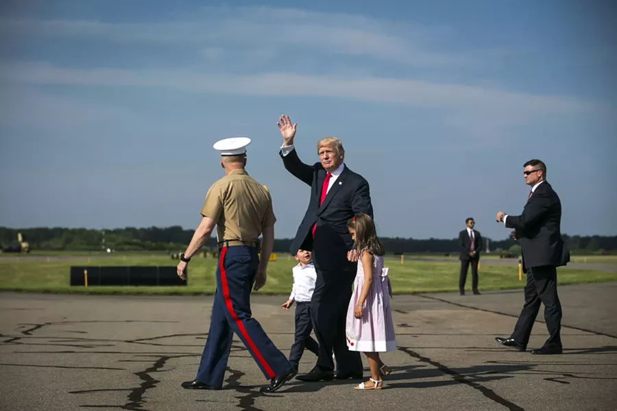 President Donald Trump walks with a military aide and his grandchildren, Arabella and Joseph Kushner, at Morristown Municipal Airport to begin his summer vacation at his Bedminster golf club, Aug. 4, 2017. - AL DRAGO/THE NEW YORK TIMES