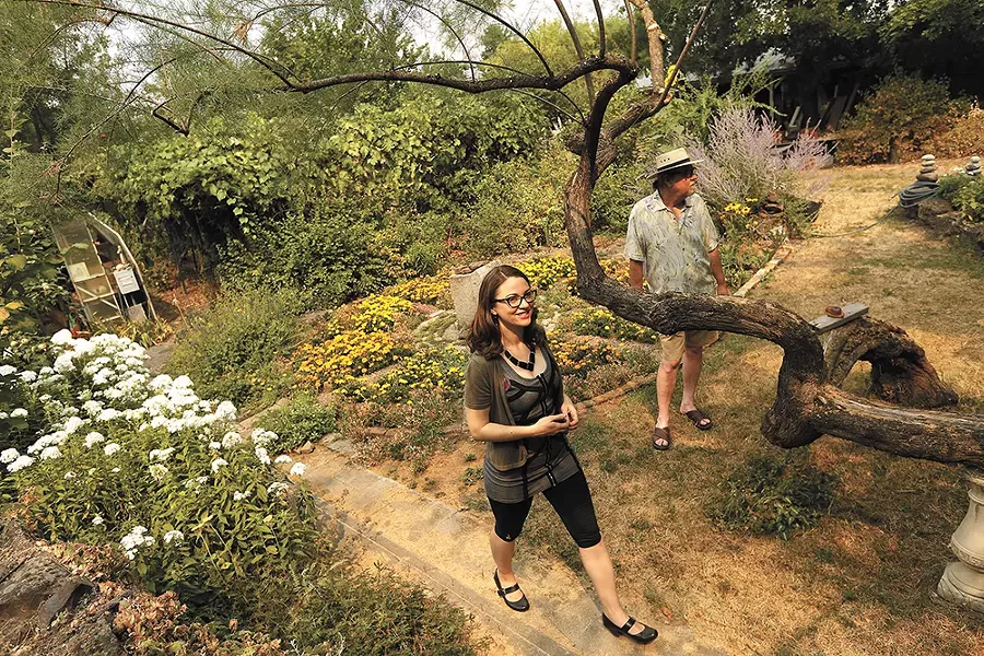 Mariah McKay and Chris Nerison stand in the garden they hope to tend as neighbors in a new community they're planning. - YOUNG KWAK