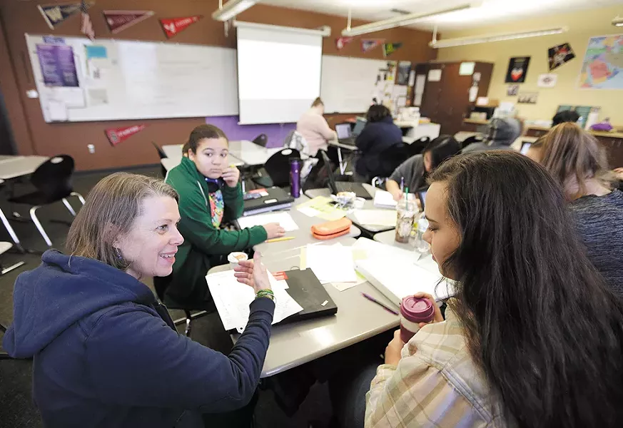 Teacher Beth McGibbon (left) works with Jamie Cahill during an AP Capstone class at Rogers High School. - YOUNG KWAK