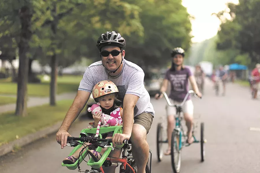 Rob Brewer and his daughter Winnie ride during Summer Parkways. - YOUNG KWAK