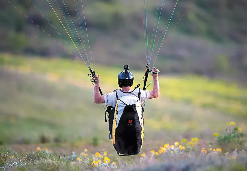 Kevin Chaupman of Spokane paraglides near Steptoe Butte. - RH MILLER