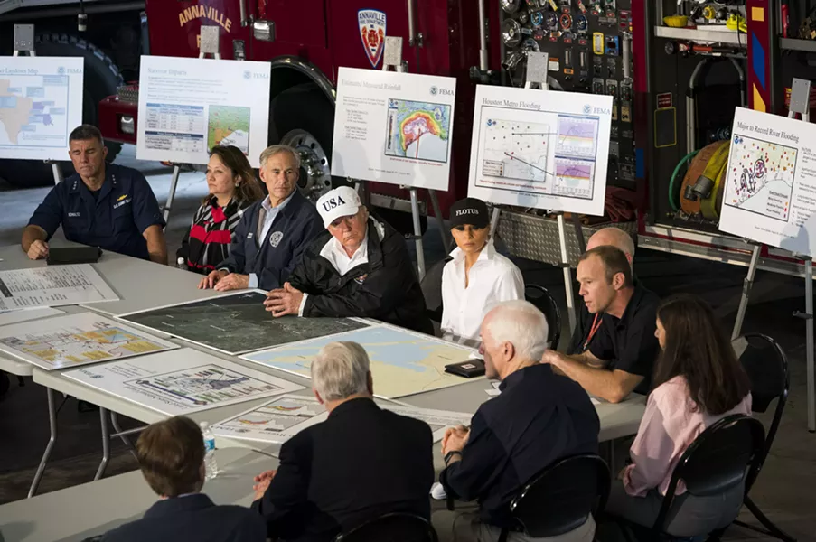 President Donald Trump participates in a briefing on relief efforts following Hurricane Harvey, at a fire station in Corpus Christi, Texas, Aug. 29, 2017. After conferring with local, state and federal emergency management officials here, Trump plans to travel to Austin, the state capital. Seated next to Trump are Gov. Greg Abbott of Texas and first lady Melania Trump. - DOUG MILLS/THE NEW YORK TIMES