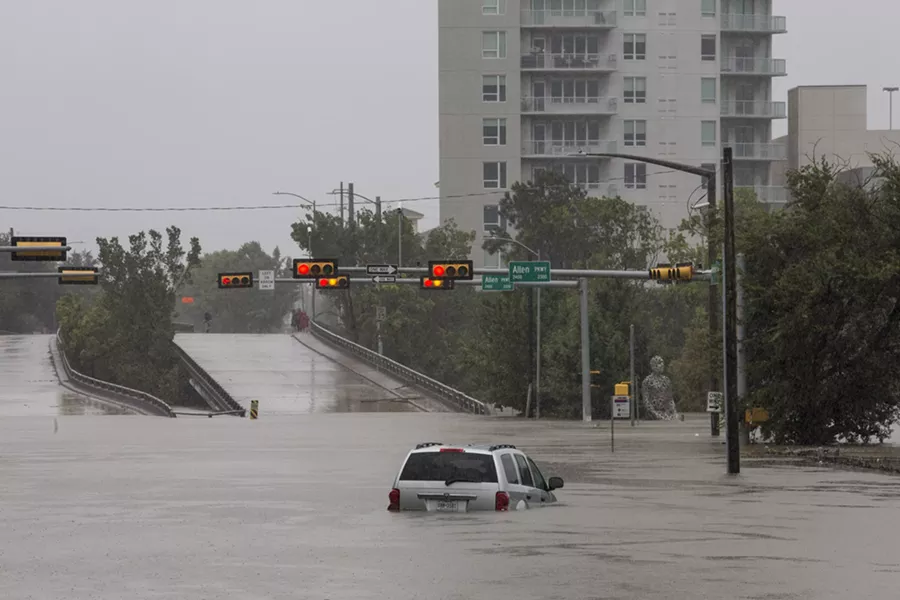 A car caught in the flooding along Buffalo Bayou and Allen Parkway in Houston, Aug. 28, 2017. With record floodwaters devastating much of southeast Texas, more than 450,000 people are likely to seek federal aid in recovering from Harvey, the storm that has battered the Gulf Coast for days, a Federal Emergency Management Agency official said. - SCOTT DALTON/THE NEW YORK TIMES