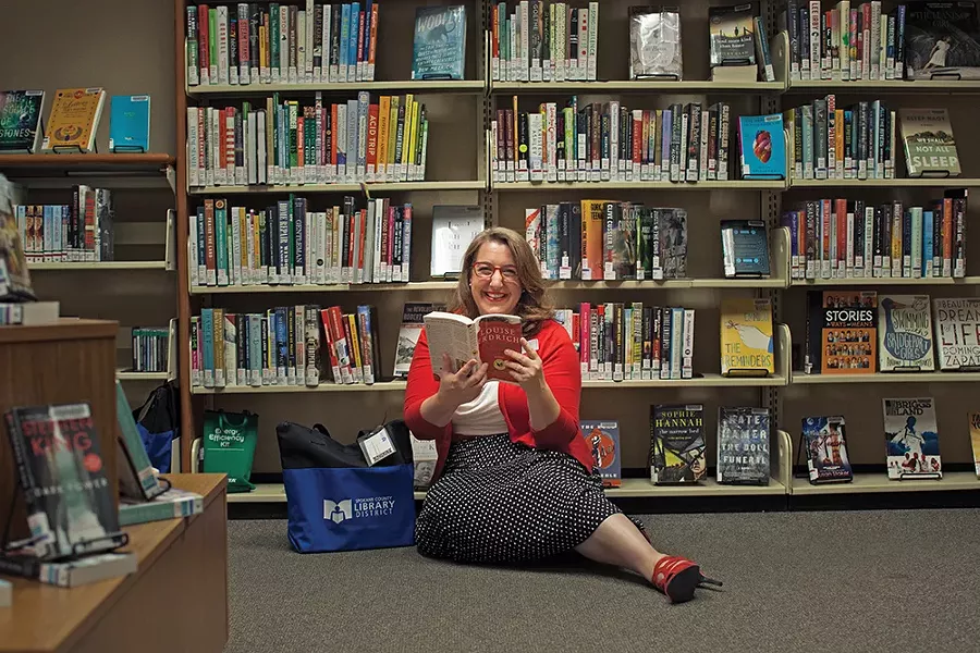 Spokane County Library Services Manager Gwendolyn Haley, with some scenes from the past 75 years. - KRISTEN BLACK