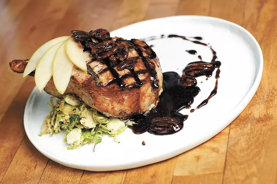 Pickled apples are a delightful garnish on Durkin's pork chop entrée. - YOUNG KWAK