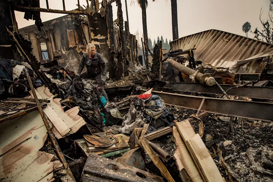 Nancy Cook sifts through the remains of her home at the Journey’s End Mobile Home Park after a wildfire passed through in Santa Rosa, Calif., Oct. 10, 2017. - JOSH HANER/THE NEW YORK TIMES