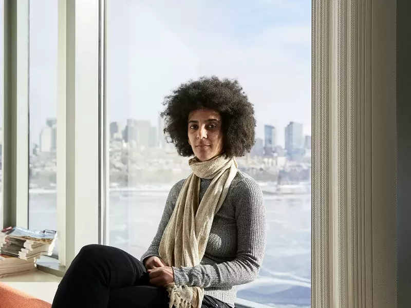 Timnit Gebru, who led a research effort based at Stanford University that analyzed 50 million images and location data from Google Street View, in Boston, Dec. 29, 2017. Artificial intelligence is making it possible for Street Views to be mined for insights about the economy, politics and human behavior — just as text mining has done for years. “This kind of social analysis using image data is a new tool to draw insights,” she said. - CODY O'LAUGHLIN/THE NEW YORK TIMES