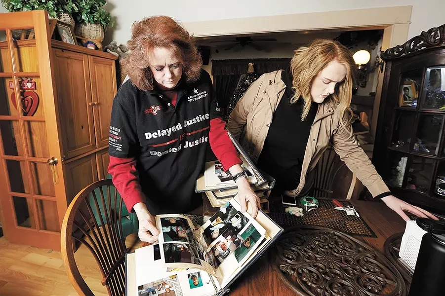 Teresa Simon and her daughter, Megan Juneau, go through old family photo albums. - YOUNG KWAK