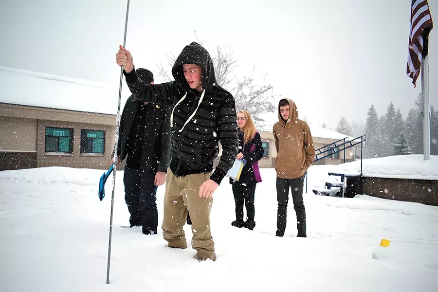 Timberlake High School sophomores Cheyenne Kiecker and Caleb Sorensen (right) watch classmate Logan Jones mark a spot to measure snowpack. - WILSON CRISCIONE